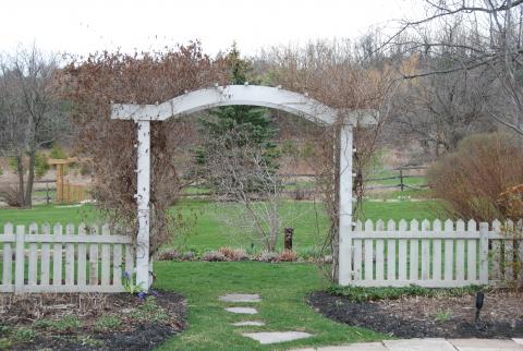 A graceful arbour and garden entrance in Milton, by Great Lakes Landscape